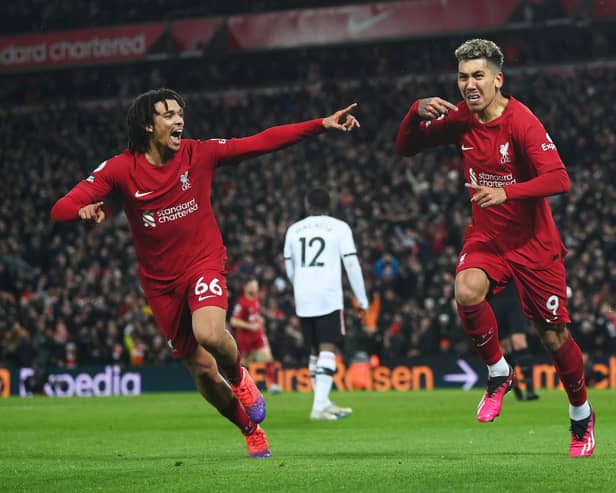 LIVERPOOL, ENGLAND - MARCH 05: Roberto Firmino of Liverpool celebrates after scoring the team's seventh goal with teammate Trent Alexander-Arnold during the Premier League match between Liverpool FC and Manchester United at Anfield on March 05, 2023 in Liverpool, England. (Photo by Michael Regan/Getty Images)