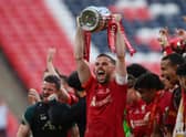 LONDON, ENGLAND - MAY 14: Jordan Henderson of Liverpool lifts The Emirates FA Cup trophy after their sides victory during The FA Cup Final match between Chelsea and Liverpool at Wembley Stadium on May 14, 2022 in London, England. (Photo by Mike Hewitt/Getty Images)
