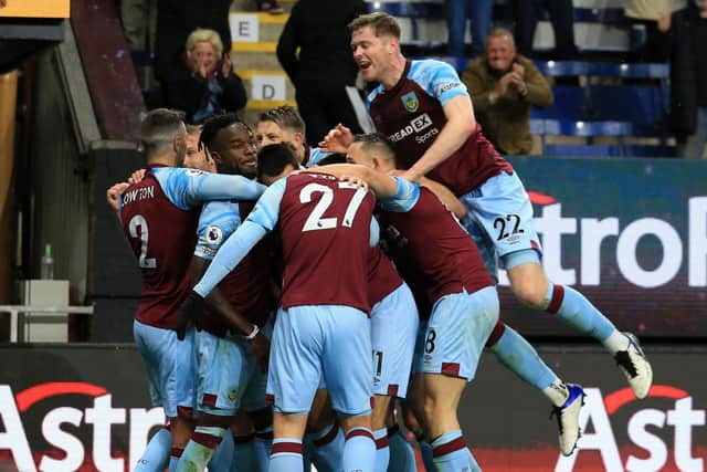 Burnley's Ivorian defender Maxwel Cornet (centre left) celebrates with teammates after scoring there third goal during the English Premier League football match between Burnley and Everton at Turf Moor in Burnley, north west England on April 6, 2022.