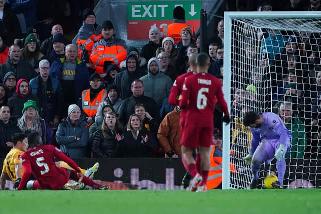 Wolverhampton Wanderers' Hwang Hee-chan (left) scores his side's second goal of the game during the Emirates FA Cup third round match at the Anfield, Liverpool.