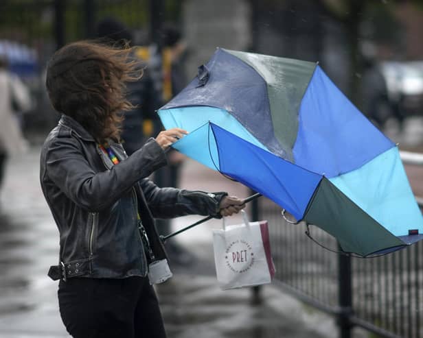 People brave the rain and wind. Photo by Christopher Furlong/Getty Images