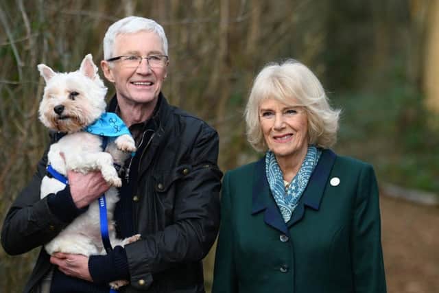 Camilla, Duchess of Cornwall, patron of Battersea Dogs and Cats Home and Battersea Ambassador Paul O’Grady on a brief woodland walk with a rescue dog. Picture: Stuart C. Wilson - WPA Pool/Getty Images