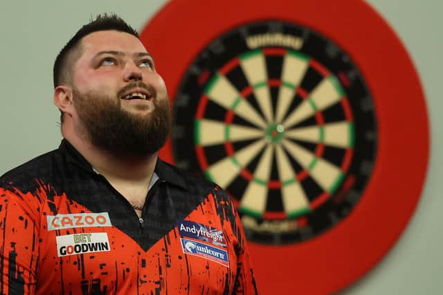 Michael Smith of England celebrates beating Michael van Gerwen of Netherlands during Day Fourteen of the Cazoo World Darts Championship at Alexandra Palace. (Picture: Luke Walker/Getty Images)