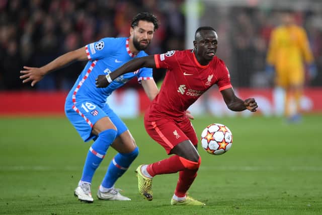 LIVERPOOL, ENGLAND - NOVEMBER 03: Sadio Mane of Liverpool holds the ball whilst under pressure from Felipe of Atletico Madrid during the UEFA Champions League group B match between Liverpool FC and Atletico Madrid at Anfield on November 03, 2021 in Liverpool, England. (Photo by Laurence Griffiths/Getty Images)