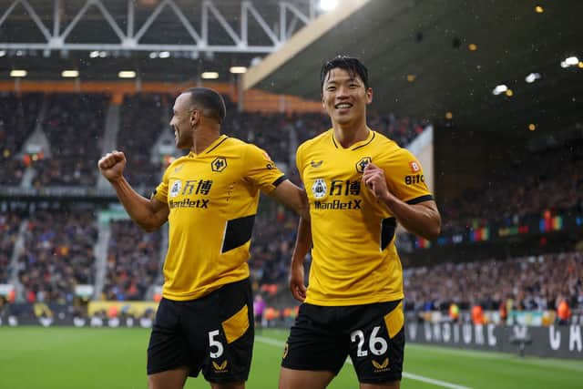 WOLVERHAMPTON, ENGLAND - OCTOBER 02: Hwang Hee-chan of Wolverhampton Wanderers celebrates with Marcal of Wolverhampton Wanderers after scoring their team's second goal during the Premier League match between Wolverhampton Wanderers and Newcastle United at Molineux on October 02, 2021 in Wolverhampton, England. (Photo by Naomi Baker/Getty Images)