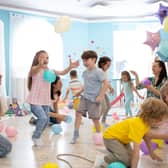 Children and their parents entertain and have fun with balloons