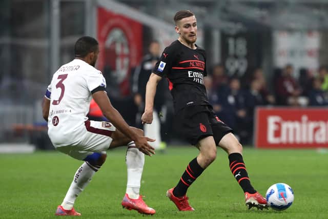 MILAN, ITALY - OCTOBER 26: Alexis Saelemaekers of AC Milan is challenged by Gleison Bremer of Torino FC during the Serie A match between AC Milan and Torino FC at Stadio Giuseppe Meazza on October 26, 2021 in Milan, Italy. (Photo by Marco Luzzani/Getty Images)