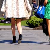 Two women wearing short skirts walk in the sunshine as upskirting, the invasive practice of taking an image or video up somebody???s clothing, becomes a specific criminal offence in England and Wales, punishable by up to two years in custody.