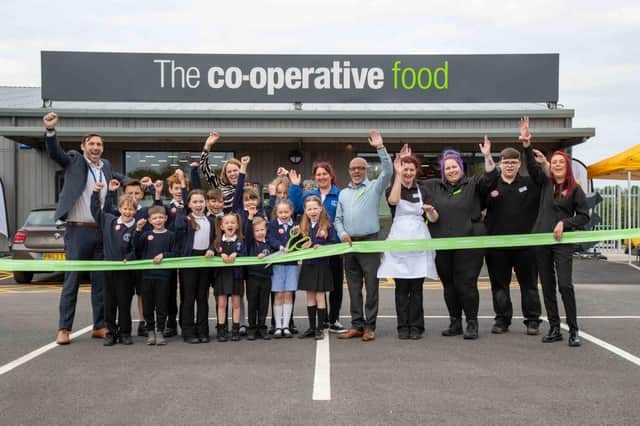 Schoolchildren from Lancaster Lane Primary School joined Central England Co-op Store Manager Saj Bax and his team to cut the ribbon.