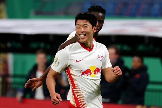 LEIPZIG, GERMANY - MARCH 03: Hee-Chan Hwang of RB Leipzig celebrates with team mates after scoring their side's second goal during the DFB Cup quarter final match between RB Leipzig and VfL Wolfsburg at Red Bull Arena on March 03, 2021 in Leipzig, Germany.  (Photo by Filip Singer - Pool/Getty Images)