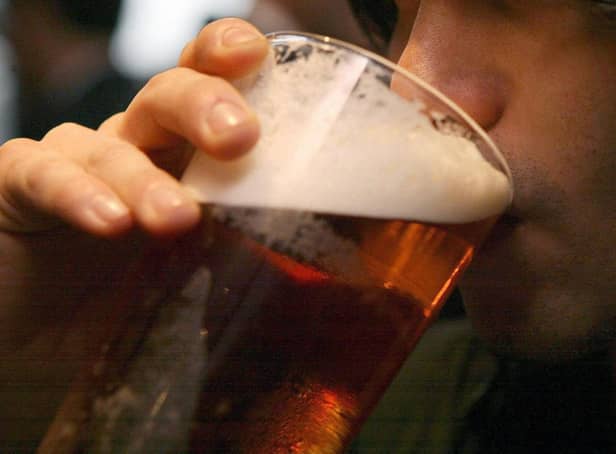 <p>Picture of someone drinking a pint of beer. Pic: PA</p>