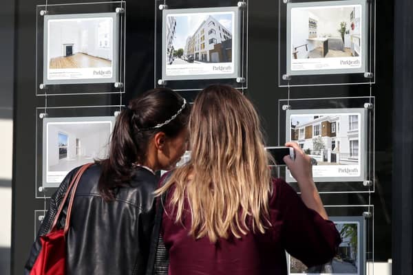 A couple of women studying the house price signs in an estate agents window. Photo: Yui Mok/PA Wire