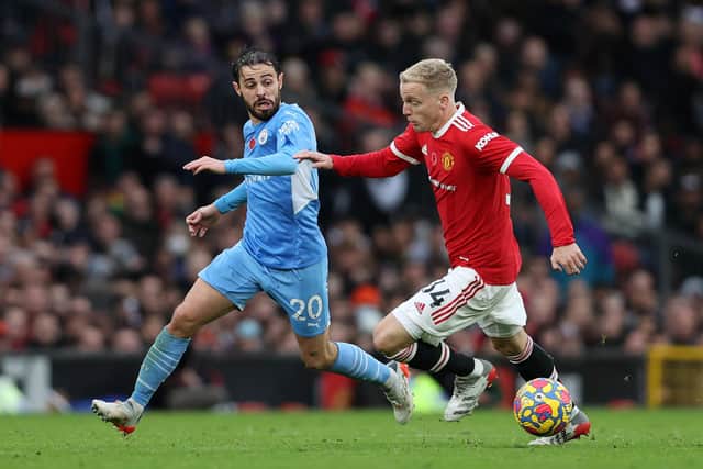MANCHESTER, ENGLAND - NOVEMBER 06: Bernardo Silva of Manchester City battles for possession with Donny van de Beek of Manchester United during the Premier League match between Manchester United and Manchester City at Old Trafford on November 06, 2021 in Manchester, England. (Photo by Clive Brunskill/Getty Images)