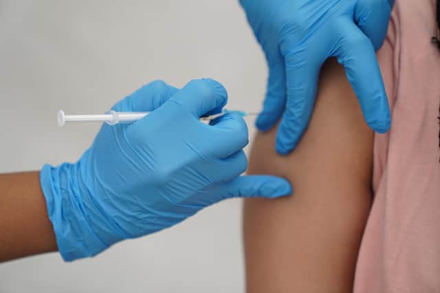 File photo dated 31/07/21 of a person receiving a Covid-19 jab, as Scottish Government ministers have been asked if there are any barriers preventing people from buying a Covid booster shot at their local pharmacy as the virus enters its third winter.