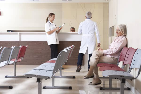 Doctors and patient in waiting room. (Shutterstock)