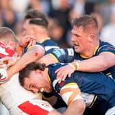 Picture by Allan McKenzie/SWpix.com - 26/05/2023 - Rugby League - Betfred Super League Round 13 - Leeds Rhinos v St Helens - Headingley Stadium, Leeds, England - St Helens's Louie McCarthy-Scarsbrook is tackled by Leeds's Cameron Smith & Tom Holroyd.