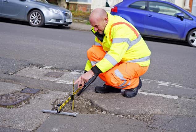 Gary Wright, senior highways inspector, at the site of a pothole reported by the public