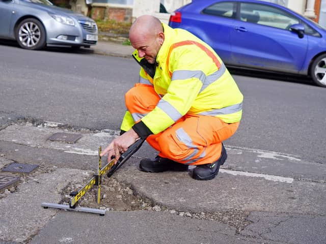 Gary Wright, senior highways inspector, at the site of a pothole reported by the public